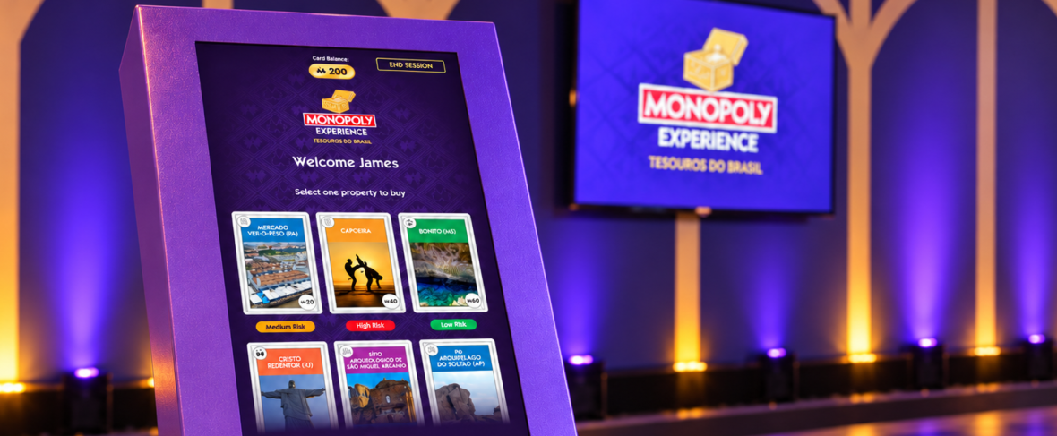 A guest interacting with the Investing Machine inside MONOPOLY Experience: Tesouros do Brasil.